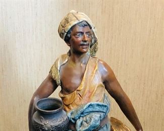 Old composition statue of man with pots, 23” tall (repaired at back of base)