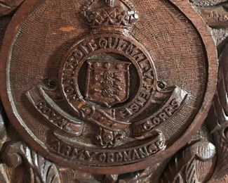 British Royal Army Ordnance Corps insignia at top of carved screen 
