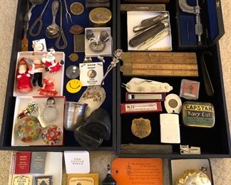 Treasures from the display case: paperweights, Santa’s, 835 silver pie server, English levels, Stanley folding rules, pocket knives, Supreme micrometer, Zippo lighter, tobacco tin, cherub ornament 