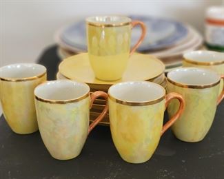Iridescent porcelain tea cups and saucers 