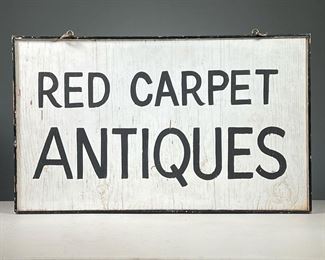 WOODEN ANTIQUES SIGN  |  Hand painted double sided hanging sign, with black lettering on a white background, reading "Red Carpet Antiques" on both sides.