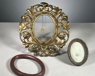 (3PC) OVAL PICTURE FRAMS  |  Includes: 1 large gilt metal picture frame with scrolled wreath border, one small 19th century French frame with easel back, and one wooden frame.