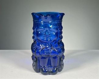 BLUE BLOWN GLASS TOBY |  An unusual blue blown glass Toby jug with clear glass applied handle.