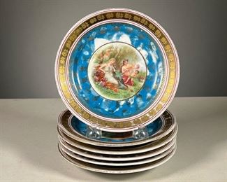 (6PC) ALLEGORICAL AUSTRIAN PLATES | A set of six hand painted plates showing women in various allegorical nature scenes, with blue and gilt borders, with crown Victoria Austria mark in underglaze blue on the bottom. 