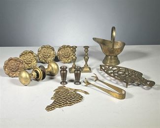 (13PC) ASSORTED BRASS PIECES  |  Including a set of 4 curtain tiebacks, 2 miniature candlesticks, a miniature coal scuttle (China),  2 miniature urns, 1 trivet (marked JM), brass tongs, a grapes plaque (marked "Made in Italy for Bonwit Teller"), & a set of vintage brass doorknobs. 