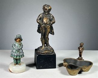 (3PC) BRASS FIGURINES  |  Includes an ashtray with a small figure of a cheeky boy,  a male figurine after Daumier [with repairs], and small cold painted girl on a white stone base. 