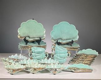 (32PC) SHELL SEA WARE SET |  A full set of shaped blue sea shell plates with teacups, all with gilt rims, includes 7 Large plates, 8 Tea Cups & Saucers with seahorse handles, 7 shell bowls, & medium-sized plate with sugar bowl; "Shell-Sea Ware / Miami Fla". 