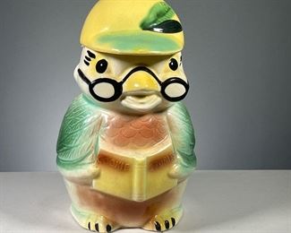 COOKIE STORIES OWL COOKIE JAR  |  Showing an owl with glasses reading a book labeled "Cookie Stories", with the owl's hat as the jar lid. Dimensions: h. 12 in