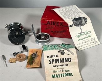(4PC) BACHE BROWN SPINNING MASTEREEL & OTHER FISHING EQUIPMENT  |  Includes: Bache Brown Mastereel with 2 Spinning Masterreels (One attached with line loaded) in original box with original paperwork, antique lure from Percy Tackle Co. and an antique cork float.