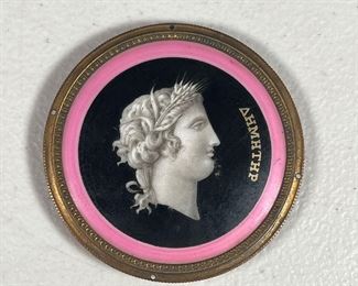 PAINTED PORCELAIN GREEK PORTRAIT  |  Painted porcelain medallion with portrait and Greek name “Dimitir” with metal border and glass cover. 
Dimensions: dia. 3 in