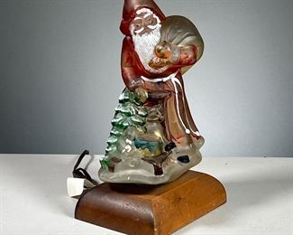 GLASS SANTA LAMP  |  Painted glass Santa Claus lamp with a tree and gifts. Dimensions: l. 6.5 x w. 5 x h. 12 in