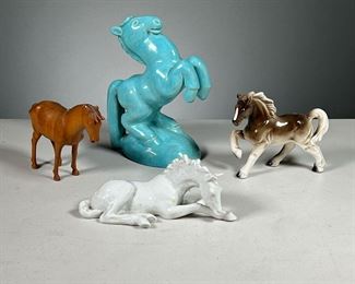 (4PC) CERAMIC HORSE FIGURINES | Includes: 1 art deco blue ceramic horse,  Japanese ceramic horse in trot, white German ceramic horse and one wooden figurine. Dimensions: w. 5.5 x h. 7 in