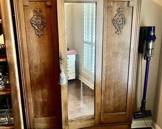 Antique oak Armiore with mirror has shelves inside and bottom drawer