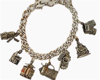 Lot #82 - Seven Vintage Sterling Silver Charms on Monet Bracelet