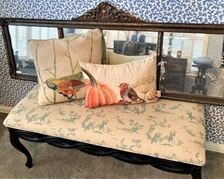 Antique mirror; decorative pillows; bench with Asian style fabric