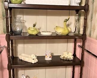 Open bookshelf with vintage pottery