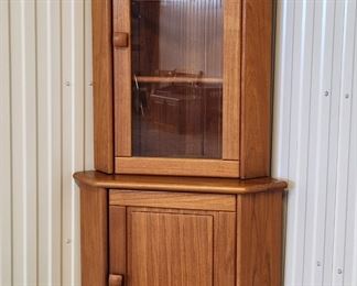 High quality Danish Modern two piece solid teak corner cabinet by Dyrlund of Denmark. Dated May 6, 1988. 