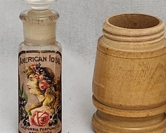 This introductory size American Ideal perfume bottle was distributed from 1912 to 1916 by the California Perfume Company, which later became Avon. It is in excellent condition with label intact and in its original wooden screw top box.