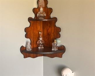 small corner shelf and little perfumes 