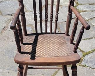 Antique highchair with caned seat