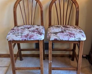 Pair of Counter Height Stools. One leg has a paint splotch. Each measure 18” wide, 25” high to the seat and 40” high to the chair back.