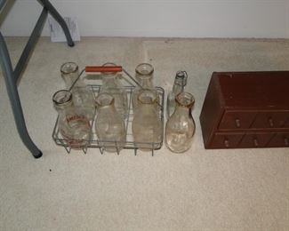 Vintage milk bottles, in the original milk crate