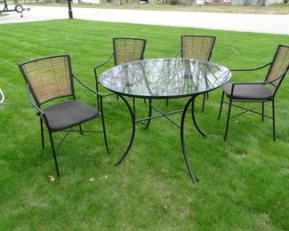 Can use indoors or outdoors.  This round glass top table and chair set
