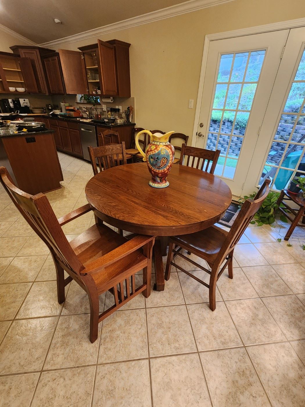 Round dining table with three leaves, 1 Captain's chair, and 3 side chairs