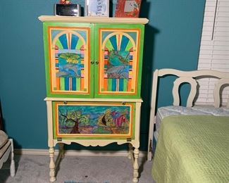 The vintage cabinet has been hand painted and looks amazing.