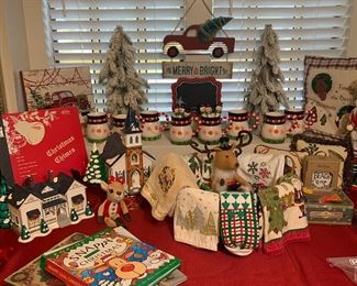 There are 2 pieces of Snow Village on this table. Can you find them?