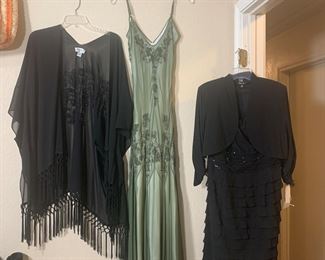 Evening dresses and evening wraps are hanging on the walls.