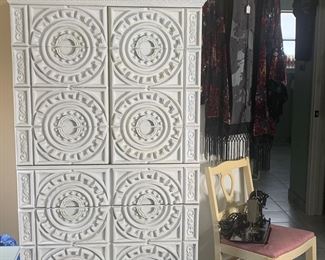 The upright chest has 2 cabinet doors that conceal open shelving. the bottom part of the chest has 4 drawers. It measures 36"W x 18" D x 69"H.