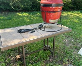 Kamado Joe Jr. portable grill, and a metal and ceramic tile indoor outdoor table