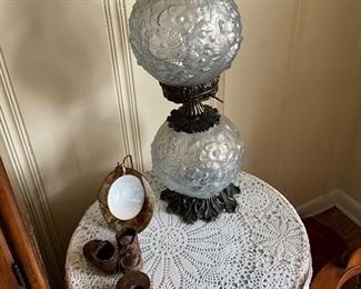 Small round table with tablecloth, lamp, decor