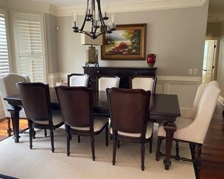 F7 - $850. Universal Furniture out of High Point. Table with 8 chairs. Measures 45” wide x 101” long (with 20” leaf in place) x 30.5” tall.  Has table pads to protect the 2. 2 captains chairs and 6 regular. Table & Chairs are in excellent condition. 