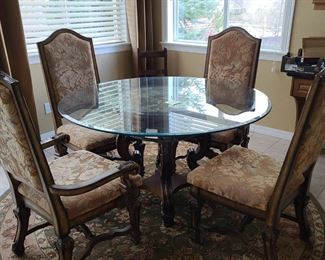 Ashley's furniture dining table glass top with two armchairs and two side chairs