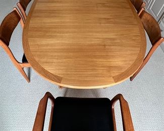 Danish Mid Century Modern Dining Room Table and Chairs. A truly lovely set in very good condition with light wear. As seen, the table measures 70.5" x 45" x 29.5" with two additional leaves stored under the table. 

Comes with six chairs featuring a lovely curved design and includes two host chairs. Looks to be by Skovby, however; no maker's mark was found. 