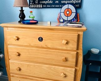 Dresser, lamp, toys, decor.