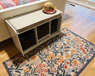 Bench with storage. Rug.