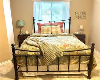 Queen iron bed and side tables, lamps.