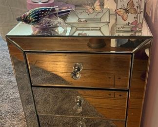 Mirrored 3 drawer cabinet/ nightstand, hand blown translucent conch shell and lavender colored items.