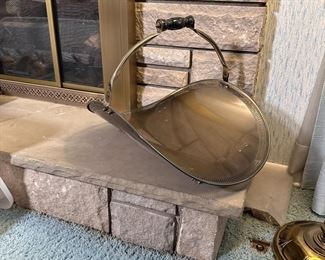 Metal firewood basket with brass finish