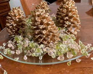 Golden pinecone candles with beaded candle rings on 12" etched glass plate