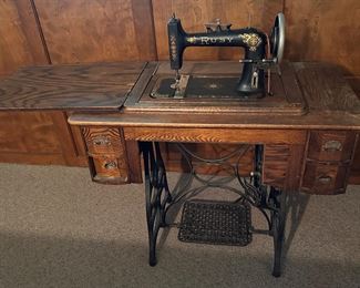 Treadle sewing machine and cabinet