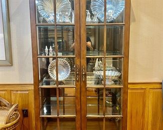 lighted curio by Century Furniture with glass adjustable shelves and a smoked mirror back