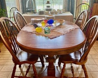 oval dining table of solid oak, by Keller Furniture, with two leaves and six chairs