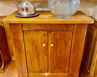 rolling island with doors on both sides, and shelves on the exterior ends