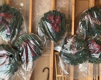 Assortment of holiday wreaths and decor