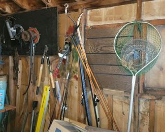 Lawn tools. Vintage snow skis and poles. Fishing gear