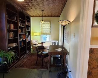 Books, leather desk chair, stained glass lamp